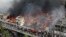 A fire rages at a popular market for cheaper clothes in Bangladesh's capital Dhaka, Bangladesh, April, 4, 2023. 
