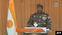 A video frame grab image from ORTN - Télé Sahel showing Niger's new military ruler General Abdourahamane Tiani, reading a statement on national television, Aug 19, 2023