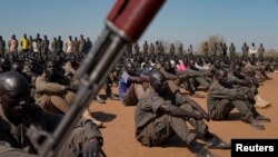 FILE - A joint force of soldiers, including soldiers from South Sudan People's Defence Forces and the Sudan People's Liberation Movement in Opposition (SPLM-IO), gathers at a training site in Gorom outside Juba, South Sudan, Feb. 17, 2020.