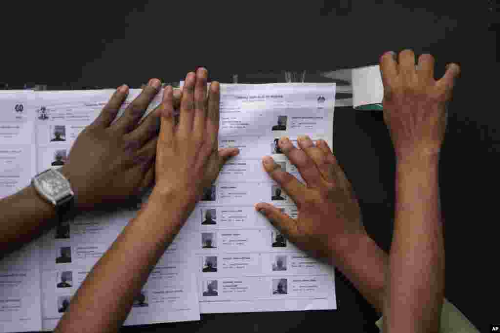 Electoral workers display on the wall a voters&#39; registration list at a polling station in Lagos, Nigeria, Saturday, Feb. 25, 2023.&nbsp;