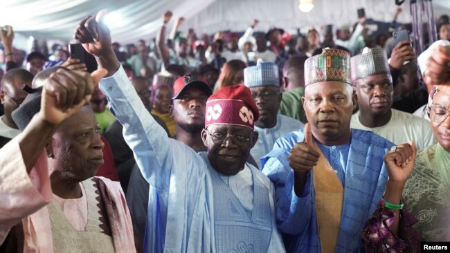 FILE - Bola Ahmed Tinubu reacts after he was declared winner in Nigeria's presidential election at his party's campaign headquarters, in Abuja, March 1, 2023.