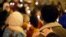 FILE - Community members gather during a candlelit vigil in support of legislation for child victims of human trafficking, Dec. 11, 2014, in Atlanta. 