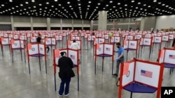 In this June 23, 2020, file photo voting stations are set up in the South Wing of the Kentucky Exposition Center for voters to cast their ballot in the Kentucky primary in Louisville, Ky.