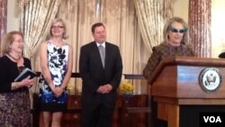 La secretaria de Estado Hillary Clinton puso la nota jocosa de la juramentación al usar lentes oscuros durante toda la ceremonia.