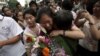 A Chinese student is greeted by a relative after attending the end of the annual college entrance examinations, in Beijing, China, Tuesday, June 8, 2010. Each year, about 10 million high school seniors across China take the "gaokao" -- the exam that is th