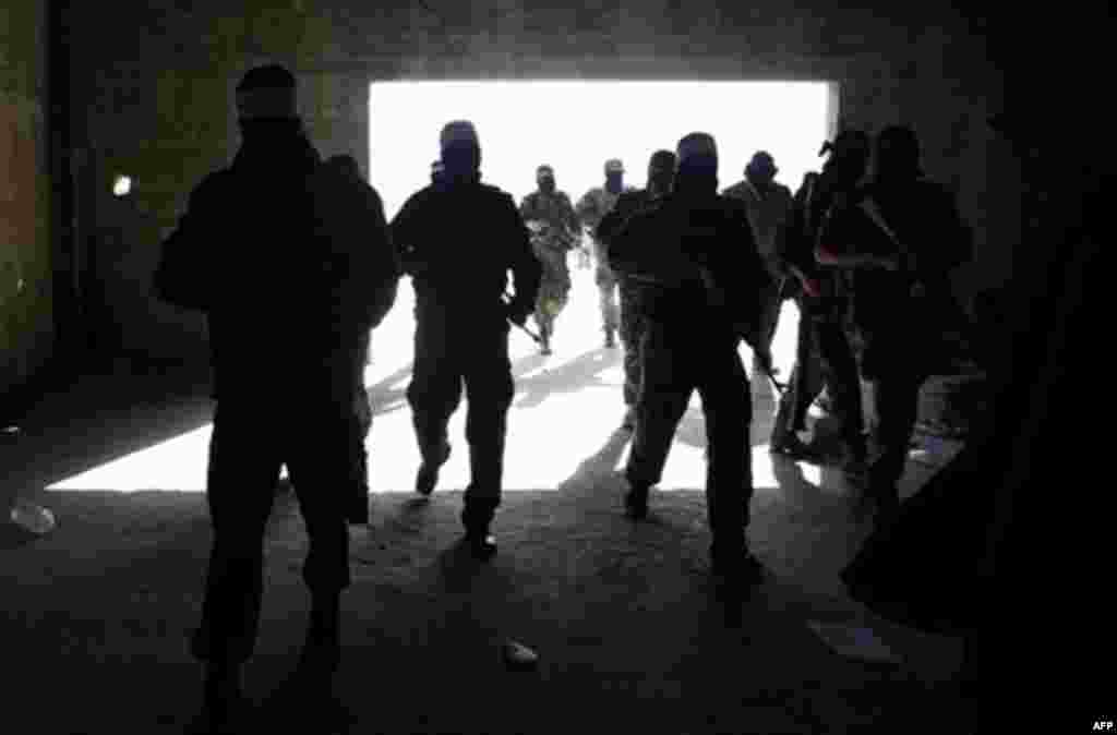 Masked Palestinian militant of the Popular Resistance Committee, a Gaza faction with close ties to the Hamas, attend a gathering to mark two years since the Israel Gaza war, in Gaza City, Monday, Dec. 27, 2010. Israel's volatile front with Gaza has been r