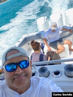 Carlos Gavidia, his family and their two dogs on their boat, SISU, crusing on the Atlantic Ocean the first Saturday after they recovered.