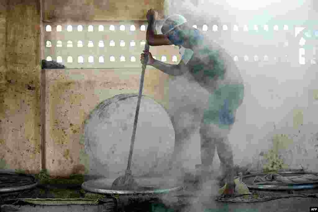 Catering chefs prepare mutton haleem for sale, during the Islamic holy fasting month of Ramadan, in Chennai, India.