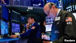 Traders work on the floor at the New York Stock Exchange (NYSE), Aug. 13, 2019. 