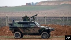 FILE - A Turkish military vehicle is seen patrolling the Turkey-Syrian border near the Akcakale border crossing in Turkey, January 2015.