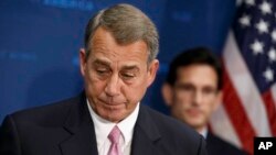 House Speaker John Boehner of Ohio, joined by House Majority Leader Eric Cantor, R-Va., right, pauses while speaking to reporters on Capitol Hill, June 10, 2014, after a Republican Conference meeting.