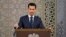 FILE - In a photo released by the official Facebook page of the Syrian Presidency, Syrian President Bashar al-Assad speaks to Syrian diplomats, in Damascus, Syria, Aug. 20, 2017.
