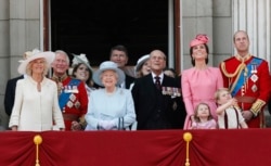 FILE - Prince Philip and Queen Elizabeth II are seen with members of the British royal family.