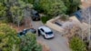 Santa Fe County deputies remain outside the house belonging to actor Gene Hackman and his wife, Betsy Arakawa, who were earlier found dead, in Santa Fe, New Mexico, Feb. 27, 2025.