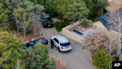 Santa Fe County deputies remain outside the house belonging to actor Gene Hackman and his wife, Betsy Arakawa, who were earlier found dead, in Santa Fe, New Mexico, Feb. 27, 2025.