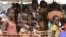 FILE - Internally-displaced people wait in line for medical attention at the 'Medecins sans Frontieres' (MSF) hospital based in the IDP camp near the international airport in Bangui, Dec. 23, 2013. 