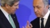 French Foreign Affairs Minister Laurent Fabius (R) speaks with U.S. Secretary of State John Kerry after a news conference at the ministry in Paris, February 27, 2013. REUTERS/Philippe Wojazer (FRANCE - Tags: POLITICS) - RTR3ECNH