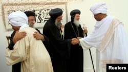 FILE - Sudan's Coptic priests (in black) welcome Muslim guests in Khartoum.