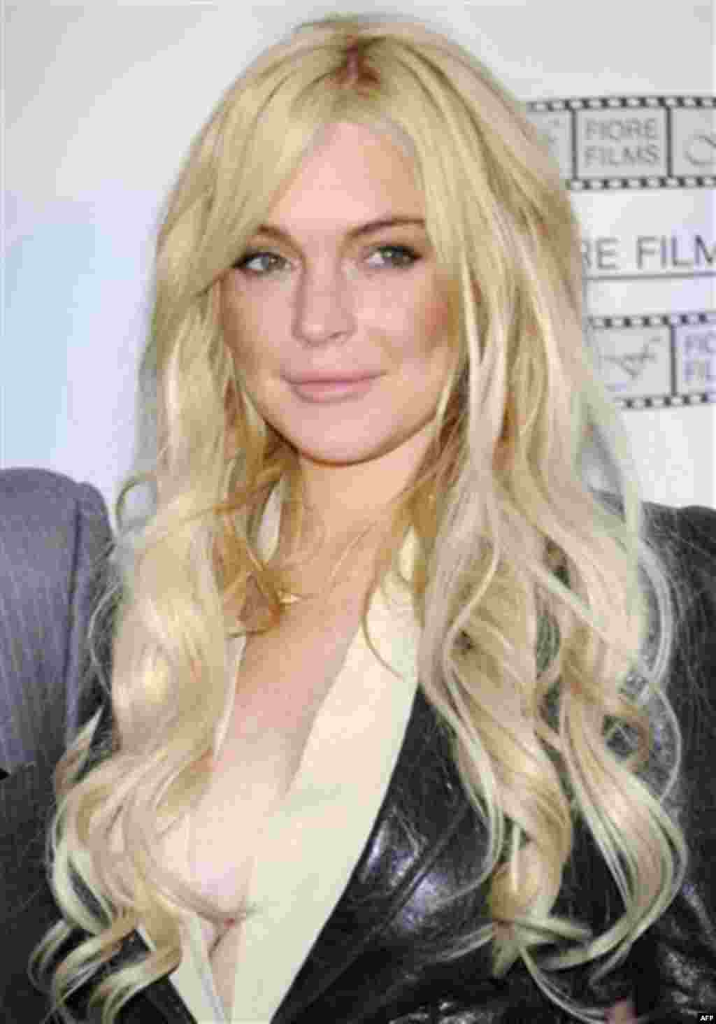 FILE In this April 12, 2011 file photo, actress Lindsay Lohan poses during a news conference for the film "Gotti: Three Generations", based on the life of John Gotti, in New York. Lohan has been released from house arrest and now the actress has to comply