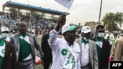 FILE - Albert Pahimi Padacke, center, waves at supporters as he arrives for a campaign rally at the Idriss Mahamat Ouya stadium in N'Djamena, Chad, March 19, 2021.