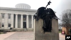 "Peace," a statue on the grounds of the Ohio Statehouse that commemorates Civil War soldiers "And The Loyal Women Of That Period," stands clear of morning fog on Wednesday, Jan. 15, 2020, in Columbus, Ohio. 