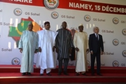 FILE - Leaders of Mali, Niger, Burkina Faso, Chad and Mauritania pose for a photo at the G5 Sahel summit in Niamey, Niger, Dec. 15, 2019.