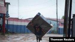 A man carries a mattress while moving to a shelter as Hurricane Iota approaches Puerto Cabezas, Nicaragua, Nov. 16, 2020. 