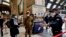 FILE - Police officers and soldiers check passengers leaving from Milan main train station, March 9, 2020. 