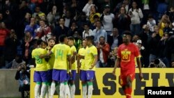 Brazilian Forward Richarlison celebrates with his teammates after scoring the third goal against Ghana during an international friendly held in France, September 23, 2022