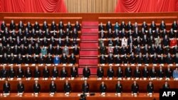 FILE - Chinese President Xi Jinping, center, and other leaders sing the national anthem during the opening session of the National People's Congress, March 5, 2023, at the Great Hall of the People in Beijing. The nation's 2024 legislative meetings will begin on March 4.