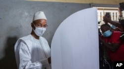 FILE - Guinean opposition leader Cellou Dalein Diallo votes in Conakry, Oct. 18, 2020.