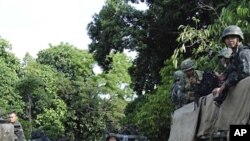 Filipino troopers secure an area at Talipao town, Sulu province, southern Philippines on Sunday, Sept. 25, 2011