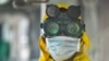 A cleaning staff wears protective gear to disinfect a metro carriage against the spreading of the COVID-19 coronavirus in Addis Ababa, Ethiopia, March 20, 2020.
