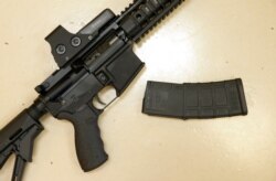 FILE - A custom-made semiautomatic hunting rifle with a high-capacity detachable magazine is displayed at TDS Guns in Rocklin, Calif. A federal judge ruled June 4, 2021, that the state's definition of illegal military-style rifles was unlawful.