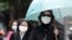 Pedestrians wearing medical masks walk on the street outside National Taiwan University Hospital in Taipei, April 26, 2013. A 53-year-old Taiwan businessman contracted the H7N9 strain of bird flu while traveling in China, the first reported case outside of mainland China. 