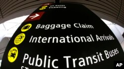 A sign for International Arrivals is shown at the Seattle-Tacoma International Airport, June 26, 2017, in Seattle. The Supreme Court said Monday that President Donald Trump's travel ban on visitors from Iran, Libya, Somalia, Sudan, Syria and Yemen can be enforced if those visitors lack a "credible claim of a bona fide relationship with a person or entity in the United States," and that justices will hear full arguments in October, 2017. 