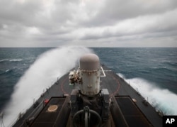 FILE - In this photo provided by the U.S. Navy, the guided-missile destroyer USS John S. McCain conducts routine underway operations in support of stability and security for a free and open Indo-Pacific, at the Taiwan Strait, Dec. 30, 2020.