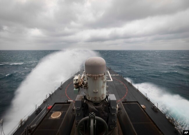 FILE - In this photo provided by the U.S. Navy, the guided-missile destroyer USS John S. McCain conducts routine underway operations in support of stability and security for a free and open Indo-Pacific, at the Taiwan Strait, Dec. 30, 2020.