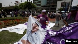 FILE - Supporters of "All for Peru" party's presidential candidate Julio Guzman are seen outside the country's electoral board in Lima, Feb. 16, 2016.