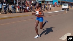 FILE - Rebecca Cheptegei competes at a 10 km road race in Kapchorwa, Uganda, Jan. 20, 2023.
