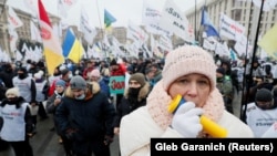 Demonstrators attend a rally of entrepreneurs and representatives of small businesses in Kyiv, Ukraine, on December 15, 2020. Entrepreneurs gathered to demand governmental support and to protest against restrictive measures introduced to curb the spread of the coronavirus.