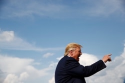 President Donald Trump speaks with reporters before boarding Air Force One at Morristown Municipal Airport in Morristown, N.J., Aug. 18, 2019.