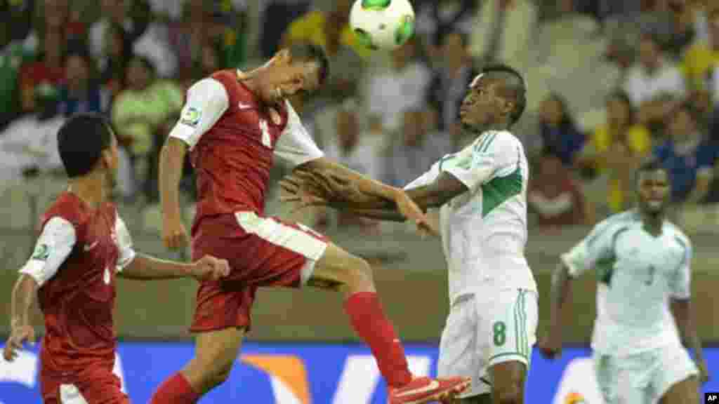 Tahiti's Ricky Aitamai, left, and Nigeria's Brown Ideye challenge for the ball during the Confederations Cup match between Tahiti and Nigeria.