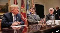 House Speaker Paul Ryan of Wis., center, and Senate Majority Whip John Cornyn, R-Texas, right, listen to President Donald Trump, left, speak during Trump's meeting with House and Senate Leadership in the Roosevelt Room of the White House in Washington, Ju