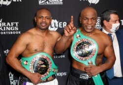 Mike Tyson and Roy Jones Jr. pose with their belts after a split draw during a heavyweight exhibition boxing bout for the WBC Frontline Belt at the Staples Center on Nov. 28, 2020. (Photo: Joe Scarnici/Handout Photo via USA TODAY Sports)