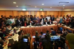 FILE - I this Feb. 22, 2020, photo, Malaysian Prime Minister Mahathir Mohamad, center right, speaks during a press conference in Putrajaya, Malaysia.