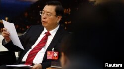 Zhang Dejiang reads his statement during a meeting held on the sidelines of the 18th National Congress of the Communist Party of China (CPC), at the Great Hall of the People in Beijing, November 8, 2012. 