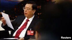 FILE - Zhang Dejiang reads his statement during a meeting held on the sidelines of the 18th National Congress of the Communist Party of China (CPC). Dejiang, who chairs China's communist-controlled legislature, is the first senior official to come to Hong Kong since the 2014 Occupy pro-democracy demonstrations. 