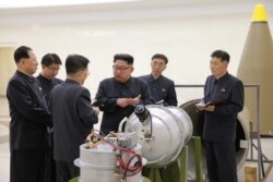 FILE - North Korean leader Kim Jong Un, center, provides guidance on nuclear weapons development in this undated photo released by North Korea's Korean Central News Agency in Pyongyang, Sept. 3, 2017.