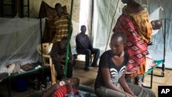 FILE - In this May 24, 2014, file photo, a South Sudanese family waits in the cholera isolation ward of Juba Teaching Hospital in the capital Juba. 